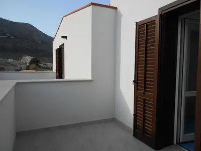 a room with a window and a white wall at Le Camere della Campana in Castellammare del Golfo