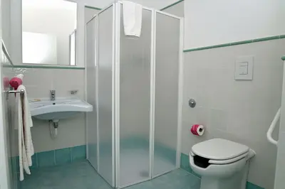 a bathroom with a shower and a toilet and a sink at Le Camere della Campana in Castellammare del Golfo
