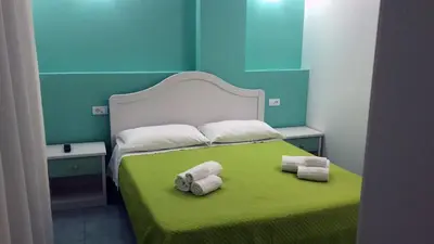 a bedroom with a bed with towels on it at Le Camere della Campana in Castellammare del Golfo
