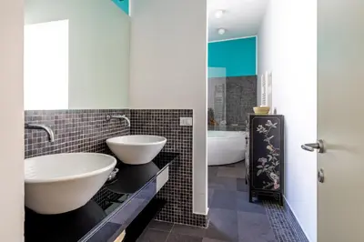 a bathroom with two sinks and a tub at Celestre all'Alloro by DomuSicily in Palermo