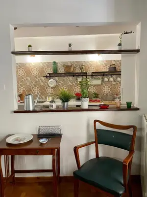 a kitchen with a table and a chair and a table and a counter at Cathedral Sweet home in Palermo