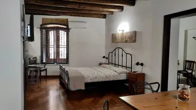 a bedroom with a bed and a table in a room at Cathedral Sweet home in Palermo