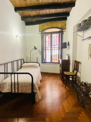 a bedroom with a bed and a wooden floor at Cathedral Sweet home in Palermo