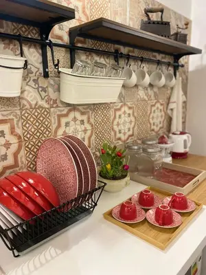 a kitchen counter with plates and bowls on a counter top at Cathedral Sweet home in Palermo