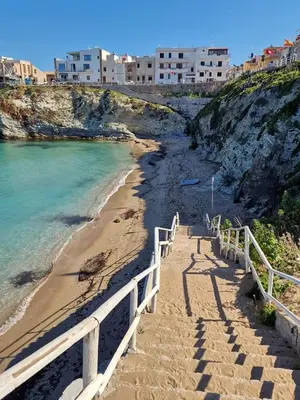 a stairway leading down to a beach with buildings at Casa Melf in Terrasini