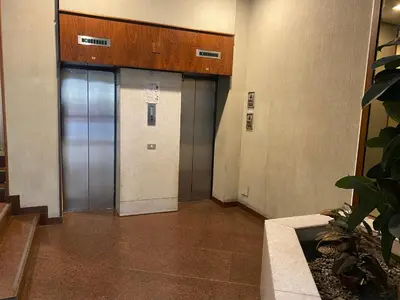a hallway with two elevators in a building at Delle Palme Rooms elegante monolocale in centro in Palermo