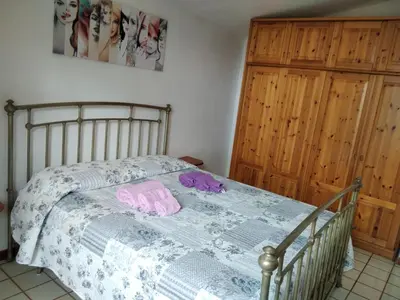 a bedroom with a bed with a blue and white comforter at casale guidaloca in Castellammare del Golfo