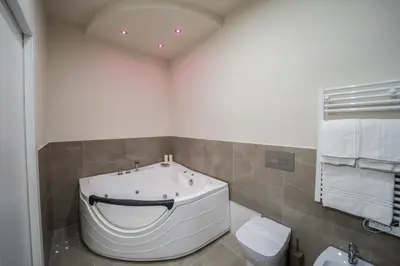 a bathroom with a large tub and a toilet at Amaris in Palermo