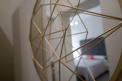 a mirror with a reflection of a room at Amaris in Palermo