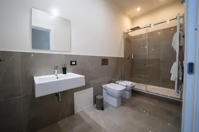 a bathroom with a sink and a toilet and a shower at Amaris in Palermo