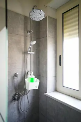 a bathroom with a shower with a sink at Click Art & Room in Trabia