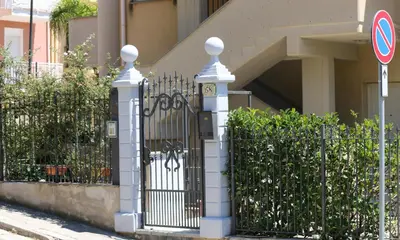 a black and white gate in front of a building at Click Art & Room in Trabia