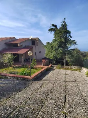 a house with a gravel road in front of it at Casa vacanze BY THE SEA in Trabia