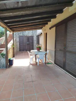 a patio with a table and chairs on a patio at Casa vacanze BY THE SEA in Trabia