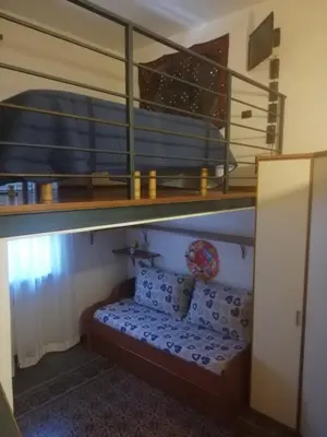 a bunk bed in a room with a bench under a bunk bed at Palermo Centrocittà in Palermo