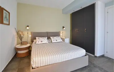 a bedroom with a bed with two pillows on it at Gorgeous Home In Balestrate With Wifi in Balestrate
