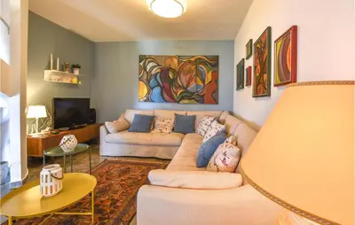 a living room with a couch and a tv at Gorgeous Home In Balestrate With Wifi in Balestrate