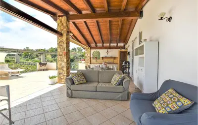 a living room with a couch and chairs on a patio at Pet Friendly Home In Balestrate in Balestrate