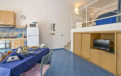 a kitchen with a table with a blue table cloth at Pet Friendly Home In Balestrate in Balestrate