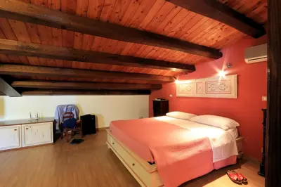 a bedroom with a large bed and wooden ceilings at Sicilia Ovest - Sea View Terrace Sofia in Castellammare del Golfo