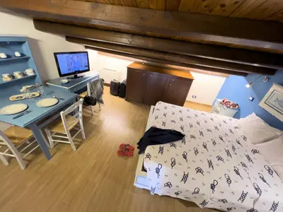 a bedroom with a bed and a desk with a computer at Sicilia Ovest - Sea View Terrace Sofia in Castellammare del Golfo