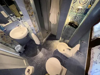 a small bathroom with a toilet and a sink at Sicilia Ovest - Sea View Terrace Sofia in Castellammare del Golfo