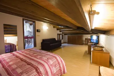 a bedroom with a bed and a couch and a television at Sicilia Ovest - Sea View Terrace Antiche Scale in Castellammare del Golfo