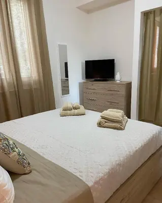 a bedroom with a bed with two towels on it at L'Oasi dell'Eremita in Mondello