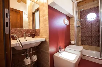 a bathroom with a sink and a toilet and a mirror at Sicilia Ovest - Terrazza Orologio e Terrazza Sul Mare in Castellammare del Golfo
