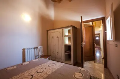 a bedroom with a bed and a cabinet in a room at Sicilia Ovest - Terrazza Orologio e Terrazza Sul Mare in Castellammare del Golfo