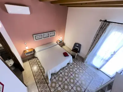 a bedroom with a white bed and a window at Sicilia Ovest - Balcone Bellavista in Castellammare del Golfo