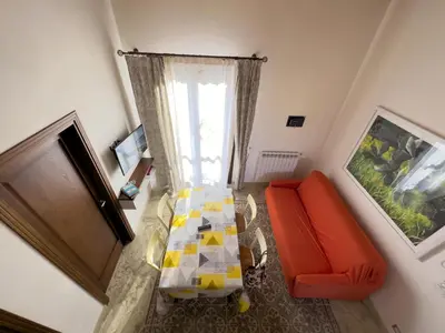 an overhead view of a living room with a orange couch at Sicilia Ovest - Balcone Bellavista in Castellammare del Golfo