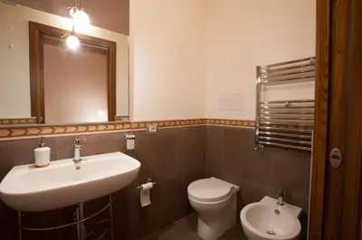 a bathroom with a sink and a toilet and a mirror at Sicilia Ovest - Balcone Bellavista in Castellammare del Golfo