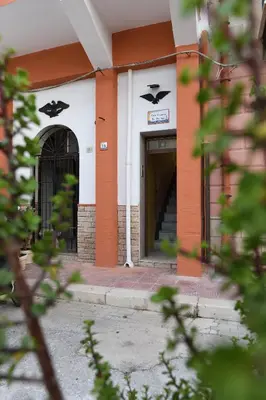 a building with a door and stairs in front of it at By the Sea Apartment #4 in Terrasini