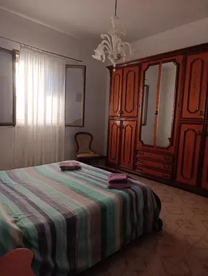 a bedroom with a bed and a dresser at Villa Giardini in Balestrate