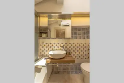 a bathroom with a sink and a toilet at Design loft Marinella in Porticello in Santa Flavia