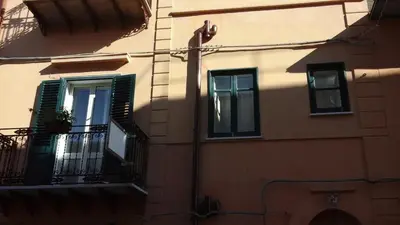 a building with a shadow on the side of it at Casa Vacanza Da Sofì in Cerda