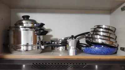 a kitchen counter with pots and pans on a stove at Casa Vacanza Da Sofì in Cerda