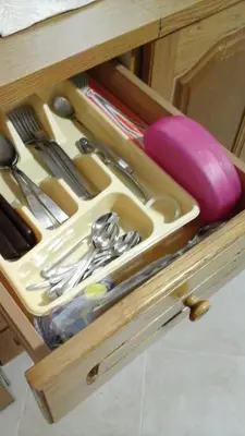 a drawer filled with utensils in a wooden drawer at Casa Vacanza Da Sofì in Cerda