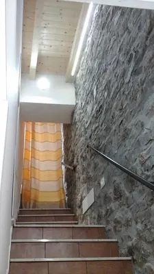 a staircase in a building with a stone wall at Casa Vacanza Da Sofì in Cerda