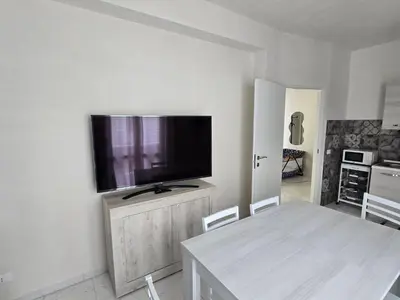 a living room with a flat screen tv on a wall at casa francesca 2 LOFTY in Castellammare del Golfo