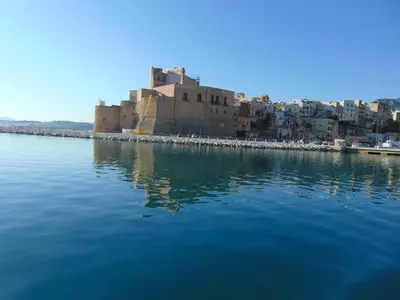 a castle on the shore of a body of water at casa francesca 2 LOFTY in Castellammare del Golfo
