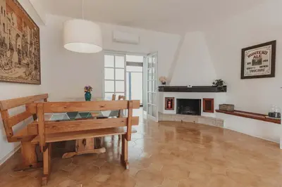 a living room with a bench and a fireplace at Villa Levante, relax esclusivo a due passi dal mare vicino Cefalù in Lascari