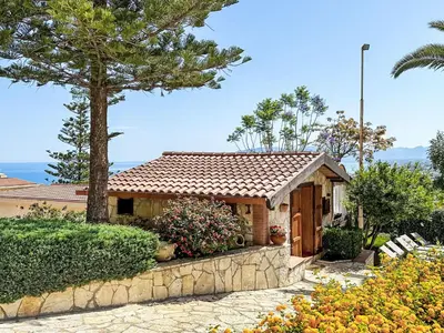 a small house with a tree and a fence at Holiday Home Melograno di Patrizia by Interhome in Castellammare del Golfo