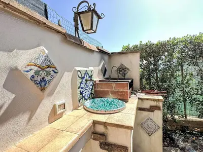 a patio with a fountain on the side of a building at Holiday Home Melograno di Patrizia by Interhome in Castellammare del Golfo