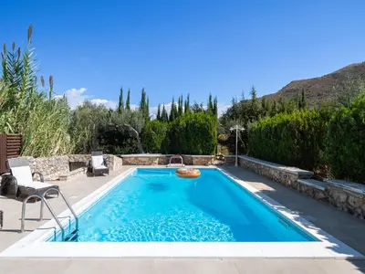 a swimming pool in a yard with a patio and trees at Villa Nicole con Dependance by Interhome in Castellammare del Golfo