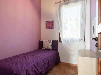 a bedroom with a purple bed and a window at Villa Nicole con Dependance by Interhome in Castellammare del Golfo
