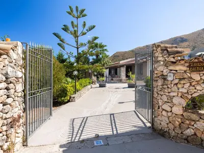 a gate to a house with a stone wall at Villa Nicole con Dependance by Interhome in Castellammare del Golfo
