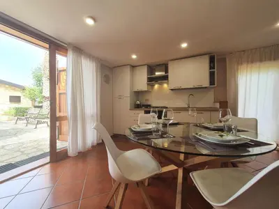 a dining room with a table and chairs and a kitchen at Apartment Edera di Patrizia by Interhome in Castellammare del Golfo