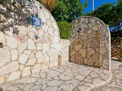 a stone wall with a stone door in a yard at Apartment Edera di Patrizia by Interhome in Castellammare del Golfo